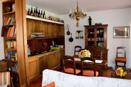 a kitchen with a table and a dining room at Casa Rosa in Pescasseroli