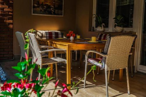 a dining room table and chairs in a room at Anna Vendégház Eger in Eger