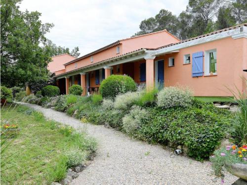 a house with a pathway leading to a yard at Villa COLIBRI in Lorgues