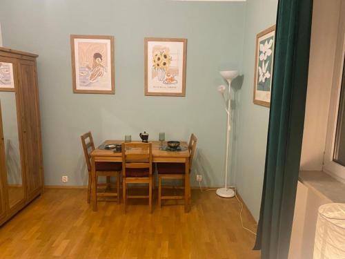 comedor con mesa de madera y sillas en Na Wspólnej Apartament, en Varsovia