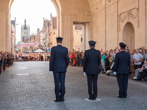 three men in uniform standing in front of a crowd at Villa Ernest in Ypres