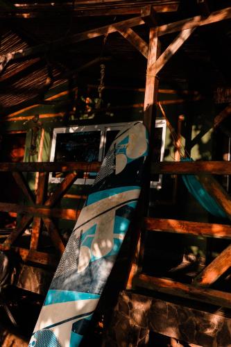 a snowboard sitting on top of a wooden ladder at El Marabu Chill'n Surf in Aposentillo