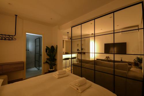 a bedroom with a bed with two towels on it at Luxury Downtown Apartment C1 in Thessaloniki