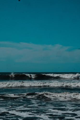 a person riding the waves in the ocean at El Marabu Chill'n Surf in Aposentillo