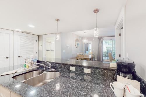 a kitchen with a sink and a counter top at Baytowne Wharf - Observation Point North #351 in Destin