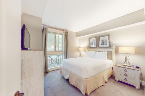 a bedroom with a large white bed and a window at Baytowne Wharf - Observation Point North #351 in Destin