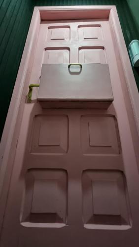 a white door with a laptop on top of it at Motel ruta slavic in Punta Arenas