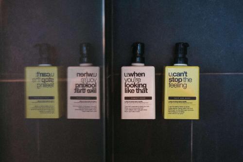 a group of three bottles of hair products on a shelf at U&Me; BW Signature Collection in Umeå