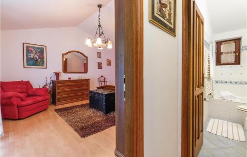 a living room with a red couch and a red chair at Gorgeous Home In Belavici With Sauna in Hreljići