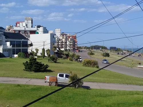 a truck parked on the side of a road at Casa duplex Frente AL Mar familiar Depto A in Mar del Plata