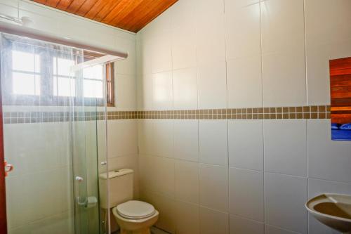 a bathroom with a toilet and a sink at Hostel Carcará in Caraguatatuba