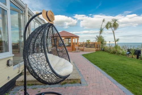 a swing hanging from the side of a house at Villa Mentone Hotel in Shanklin