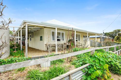 a house with a fence in front of it at 18 Herbert Street Normanville in Normanville