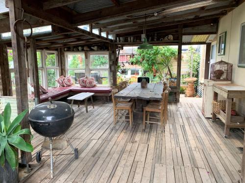 a patio with a table and chairs and a grill at 18 Herbert Street Normanville in Normanville