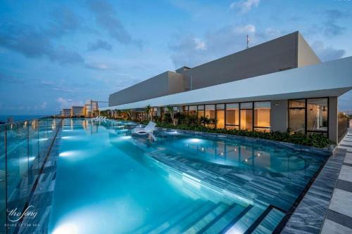 a large swimming pool in front of a building at Lucky House - Second Home in The Sóng Vũng Tàu in Vung Tau