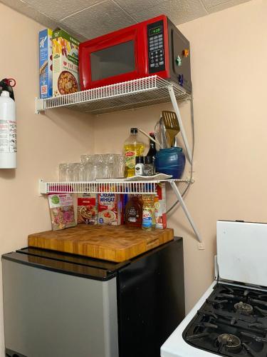 a kitchen with a microwave on top of a refrigerator at Boho-Chic Studio - Unit 1 in Bloomington