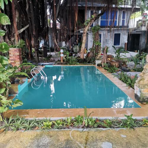 a swimming pool in the middle of a yard at Anodash Homestay in Baan Tai