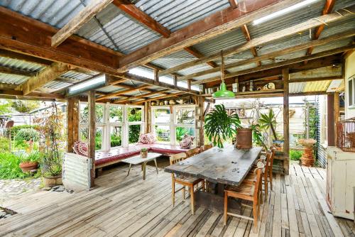 an outdoor patio with a wooden table and chairs at 18 Herbert Street Normanville in Normanville