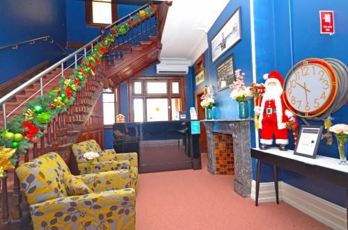 a room with a staircase with a santa claus and a clock at The Hallows Accommodation in Bathurst