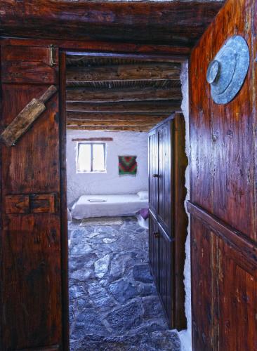 an open door to a room with a bed at Aspros Potamos in Makry Gialos