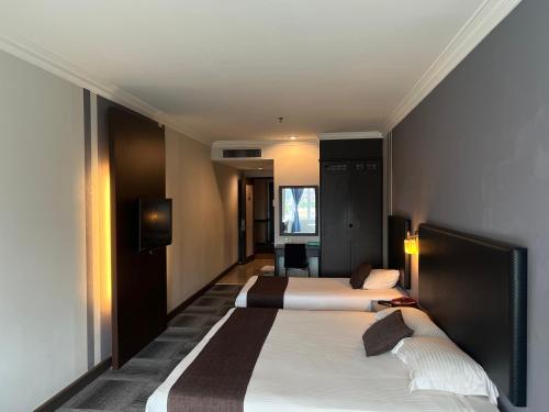 Кровать или кровати в номере Legend Inn Taiping
