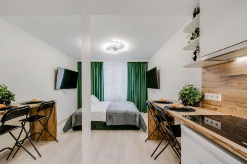 a small room with a bed and a kitchen at Stylish Apartment in Zverynas in Vilnius