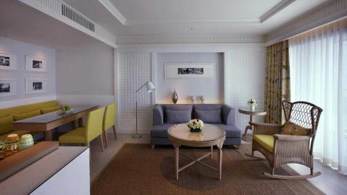 a living room with a couch and a table at Amari Hua Hin in Hua Hin