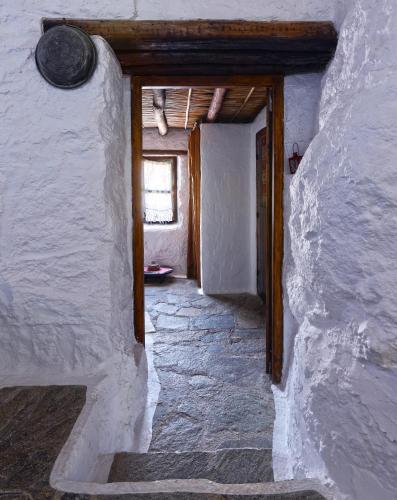 a hallway of a house with a door and a window at Aspros Potamos in Makry Gialos