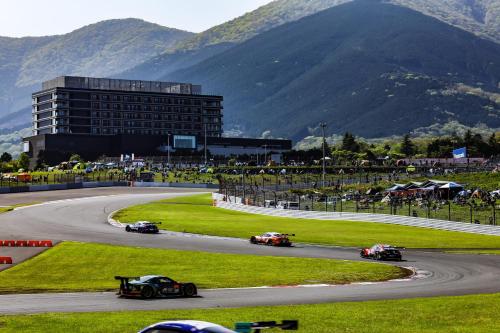 a group of cars driving around a race track at Fuji Speedway Hotel - The Unbound Collection by Hyatt in Oyama