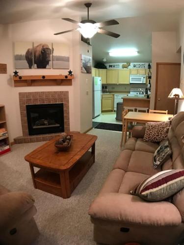 a living room with a couch and a fireplace at Cozy 2 BR Mountain View - walk to resort in Big Sky