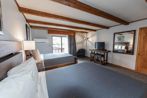 ein Hotelzimmer mit 2 Betten und einem Spiegel in der Unterkunft Hotel Vienna in Windham
