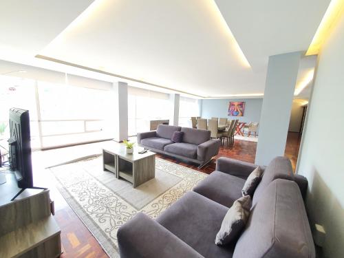 a living room with a couch and a tv at Luxury Apartment Masaryk 4BR in Mexico City