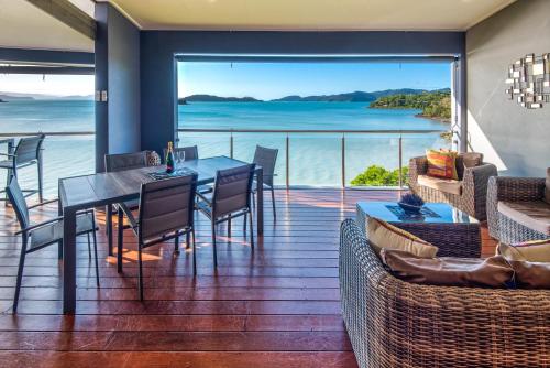 a dining room with a view of the ocean at Edge Apartments on Hamilton Island by HIHA in Hamilton Island