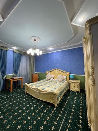 sypialnia z łóżkiem i niebieską ścianą w obiekcie Гостиница Селена w Kyzyłordzie