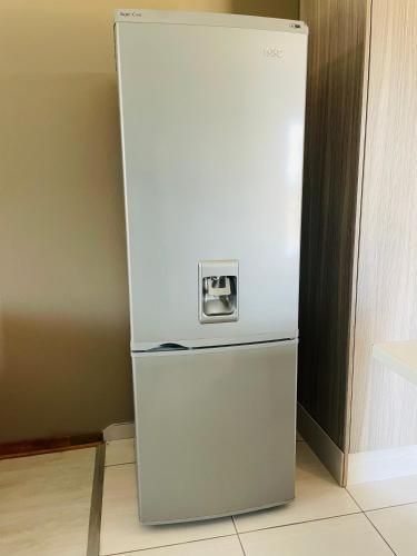 a white refrigerator is sitting in a kitchen at Moh Ville Guest House in Maseru