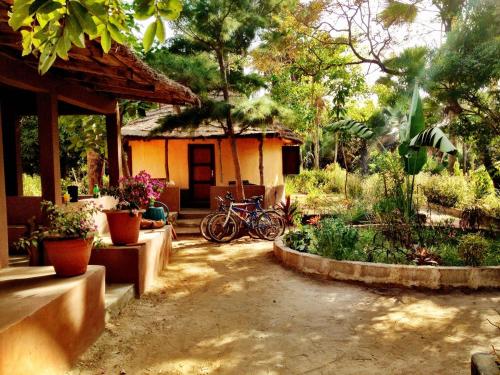 a house with bikes parked in front of a yard at Nemasu Eco-lodge in Gunjur