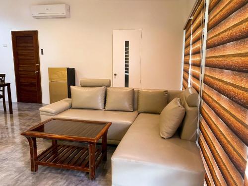 a living room with a couch and a coffee table at Casa De Española Hotel and Resort in Aritao