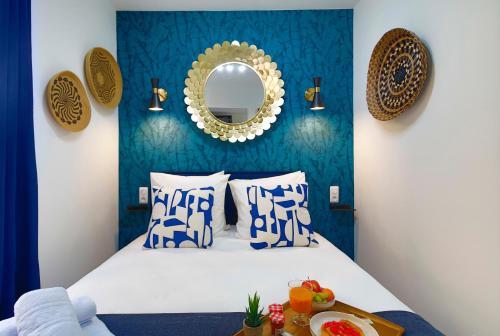 a bedroom with a bed with blue walls and a mirror at Apartments WS Opéra - Laffitte in Paris