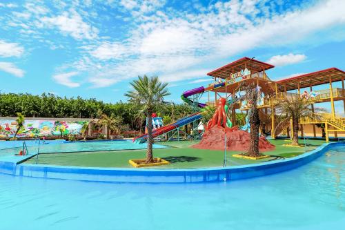 a water park with a water slide in the middle at Trang Villa Hotel and Water Park in Trang