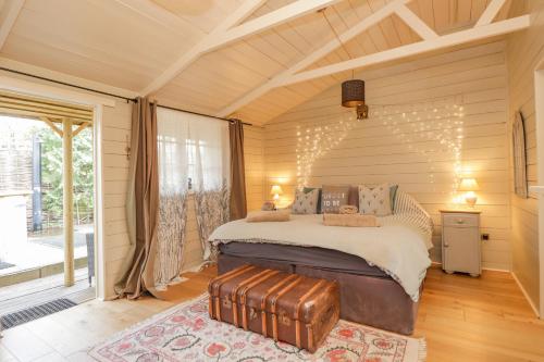 a bedroom with a bed with a suitcase in it at Wild Rose Retreat in Ashford