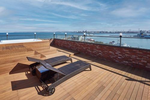 a wooden deck with a table and benches on a boat at Browndot Terrace Pohang Passenger Terminal in Pohang