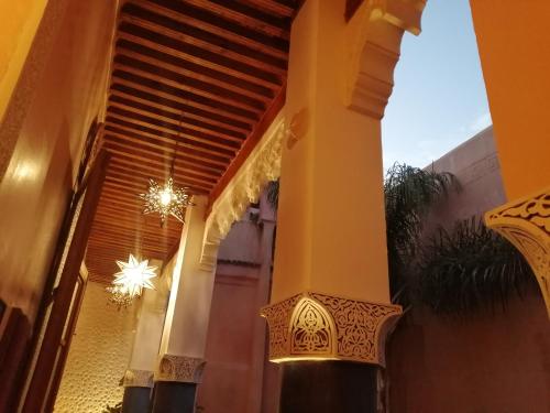 a porch of a house with a chandelier at Les Bains de Fez Tara in Fès