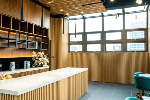 a kitchen with a counter and a large window at HOTEL LEISURE Kaohsiung in Kaohsiung