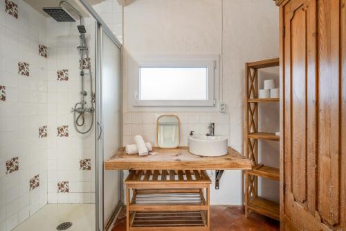 a bathroom with a sink and a mirror at Villa Torret 46 in Sant Lluis