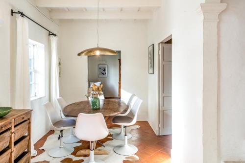 a dining room with a table and chairs at Villa Torret 46 in Sant Lluis