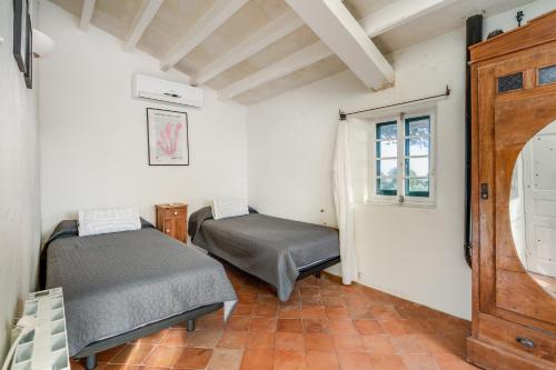 a room with two beds and a window at Villa Torret 46 in Sant Lluis