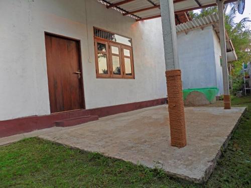 a house with a door and a pole in front of it at Jegers Villa in Negombo