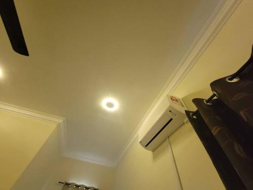a room with a ceiling with a light on it at NusaTuah Roomstay in Malacca