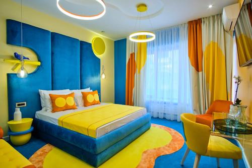 a bedroom with a bed and a dining room at Vilacrosse Boutique Inn in Bucharest