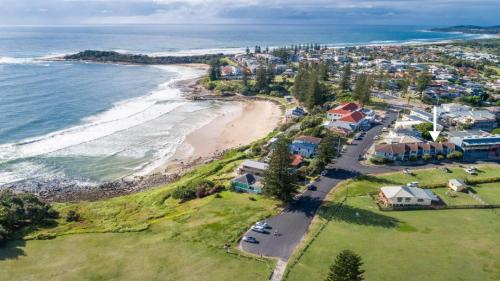 an aerial view of a beach with houses and the ocean at Lighthouse unit 2 in Yamba